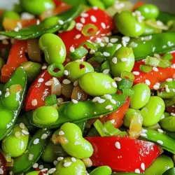 To make the Spicy Garlic Edamame Stir-Fry, you need a few key items. These ingredients create the base of the dish. Here’s what you’ll need: - 2 cups shelled edamame (fresh or frozen) - 1 tablespoon sesame oil - 3 cloves garlic, minced - 1 tablespoon fresh ginger, minced - 1 red bell pepper, sliced - 1 cup snap peas - 1-2 tablespoons soy sauce (low sodium) - 1 tablespoon chili paste (adjust for spice preference) - 1 teaspoon honey or agave syrup - 2 green onions, chopped - Sesame seeds for garnish - Fresh cilantro for garnish (optional) These ingredients work together to give the dish a bold flavor. Edamame provides protein, while garlic and ginger add zest. For a great stir-fry, fresh ingredients are vital. Make sure to choose fresh veggies for the best taste. You can also use pantry staples. Here are some ideas: - Fresh vegetables like broccoli or carrots can add color. - Use different types of beans for varied texture. - Swap soy sauce for tamari if you need a gluten-free option. Feel free to mix and match. This keeps your dish exciting and new each time you make it. To take your stir-fry to the next level, consider adding some garnishes. They not only add flavor but also a pop of color. Here are some tasty options: - Chopped green onions for a mild onion flavor. - Sesame seeds add crunch and nutty notes. - Fresh cilantro gives a bright finish. These garnishes can elevate your dish. They help create a beautiful plate that looks as good as it tastes. Enjoy crafting your Spicy Garlic Edamame Stir-Fry with these tips and the [Full Recipe]. Start by preparing your edamame. If you use frozen edamame, boil it in water for 3-5 minutes. This step ensures they get tender. Drain the edamame and set it aside. Next, gather your other ingredients. Slice the red bell pepper and mince the garlic and ginger. Chop the green onions and measure out the soy sauce, chili paste, and honey. Having everything ready will help you cook faster. Heat a large skillet or wok over medium heat. Add the sesame oil and let it warm up. Once it’s hot, add the minced garlic and ginger. Sauté them for 1-2 minutes until they smell great. Then, toss in the sliced red bell pepper and snap peas. Cook these for about 3-4 minutes. They should soften but remain crisp. Next, add the cooked edamame to the skillet. Drizzle the soy sauce, chili paste, and honey over the mixture. Stir well to mix all the flavors. Cook everything for an additional 2-3 minutes. This allows the edamame to heat and the flavors to blend nicely. Combining ingredients is key for great stir-fry. Make sure to add your veggies in stages. Start with the ones that take longer to cook, like bell peppers. Then, add the quicker-cooking items, like edamame. This will ensure everything cooks evenly. Stir gently but frequently to prevent burning. Keep your heat at medium. This way, you avoid overcooking the garlic and ginger. Lastly, taste as you go. Adjust the soy sauce or chili paste to fit your spice preference. For the full recipe, refer to the earlier section. To make your dish just right, start with one tablespoon of chili paste. If you love heat, add more. You can also use fresh chili peppers for a different kick. Just remember, you can always add more spice, but it’s hard to take it out once it’s in! Use fresh or frozen edamame for great taste. If using frozen, boil for three to five minutes. This quick cook makes them tender but still firm. Always drain well. Too much water can make your stir-fry soggy. Prep your veggies ahead of time. Chop your bell pepper and green onions the night before. Store them in the fridge. You can also use pre-shelled edamame. This cuts down your cooking time. If you have a busy day, make double and save half for later. The flavors only get better! For the full recipe, check out the Spicy Garlic Edamame Stir-Fry section. {{image_2}} This dish is already plant-based, making it great for vegetarians and vegans. You can keep it simple or add more veggies. Try adding mushrooms or zucchini for extra texture. If you want a creamier sauce, blend in some coconut milk. This adds richness without losing that fresh taste. To make this stir-fry more filling, consider adding protein. Tofu is a great choice. You can press it, cube it, and sauté it first. Tempeh is another option that adds a nutty flavor. If you eat meat, chicken or shrimp can work well too. Just cook them before adding the veggies and edamame. Feel free to get creative with your ingredients. Instead of red bell pepper, use yellow or green for a different taste. Swap snap peas for broccoli or bok choy. For a twist, try adding a splash of lime juice or rice vinegar. If you want it sweeter, you can increase the honey or agave syrup. Each swap can change the dish’s flavor and keep it exciting. For full details, check the Full Recipe. To store leftover stir-fry, let it cool to room temperature. Place it in an airtight container. Make sure to refrigerate it within two hours. This helps keep the flavors fresh. Leftover stir-fry can last in the fridge for 3 to 5 days. Always label the container with the date to track freshness. When reheating, use a skillet or a microwave. For a skillet, add a splash of water to keep it moist. Heat over medium-low heat, stirring often. If using a microwave, cover the dish. Heat for 1-2 minutes, stirring halfway through. This helps to avoid hot spots. Always check the temperature to ensure it’s heated through. You can freeze the stir-fry for later use. Allow it to cool completely before freezing. Use freezer-safe bags or containers. Remove as much air as possible to prevent freezer burn. Label each bag with the date. The stir-fry can last about 2-3 months in the freezer. To use, thaw overnight in the fridge before reheating. For the full recipe, check out the Spicy Garlic Edamame Stir-Fry. Enjoy your cooking! Yes, you can use frozen edamame in this recipe. In fact, it works great! Just cook the frozen edamame in boiling water for 3-5 minutes. This makes it tender and ready for the stir-fry. After cooking, drain the edamame and set it aside. Using frozen edamame saves time and is still very tasty. This stir-fry goes well with many dishes. Here are a few ideas: - Brown rice or jasmine rice - Quinoa for a healthy twist - Grilled chicken or tofu for protein - A fresh salad to balance the heat - Spring rolls for a fun starter These pairings create a full meal and enhance the flavors of the edamame stir-fry. To make this dish gluten-free, use tamari instead of soy sauce. Tamari is a gluten-free soy sauce that tastes similar. Always check the label to ensure it’s gluten-free. Also, make sure any chili paste you use is gluten-free. This way, you can enjoy the spicy garlic edamame without worry. In this article, we explored the essentials for making a spicy garlic edamame stir-fry. We covered key ingredients, cooking steps, and tips to enhance flavor. You now know how to adjust spice levels and make variations based on your taste or diet. Remember, cooking is about fun and creativity. Don’t be afraid to experiment with new ingredients. Enjoy your delicious dish and feel proud of your kitchen skills!