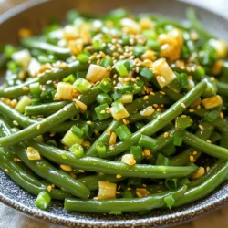 For this tasty dish, you need: - 1 pound fresh green beans, trimmed - 3 tablespoons sesame oil - 4 cloves garlic, minced - 1 tablespoon fresh ginger, minced - 2 tablespoons soy sauce (or tamari for gluten-free) - 1 tablespoon rice vinegar - 1 tablespoon honey or maple syrup - 2 tablespoons sesame seeds, toasted - Salt and pepper to taste - Chopped scallions, for garnish Choosing fresh green beans is key. Look for beans that are bright green and firm. They should snap easily when bent. Sesame oil adds a rich flavor, while garlic and ginger bring warmth and depth. Fresh ingredients make a big difference. Always check for the following: - Green beans should look vibrant and not wilted. - Garlic cloves should be firm and dry. - Ginger should feel heavy and have smooth skin. Store green beans in the fridge. Use them within a few days for the best taste. You can adjust this recipe for your needs: - Use tamari instead of soy sauce for gluten-free. - Swap honey for maple syrup to make it vegan. - If you don’t have sesame seeds, try chopped nuts for crunch. These swaps keep the dish flavorful while meeting different dietary choices. Enjoy cooking! Start with fresh green beans. Trim the ends to remove any tough spots. This keeps the beans tender. You will need one pound for this recipe. Bring a large pot of salted water to a boil. This helps to brighten the color of the beans. Blanch the beans by cooking them in boiling water for 2-3 minutes. This step makes the beans bright green and tender-crisp. Once done, quickly transfer them to an ice bath. This stops the cooking and keeps the beans crisp. Drain the beans and set them aside. Grab a large skillet or wok and heat 3 tablespoons of sesame oil over medium-high heat. Add 4 cloves of minced garlic and 1 tablespoon of minced ginger. Sauté these for about 30 seconds until they smell great. Now, add the blanched green beans to the skillet. Stir well to coat them in the garlic and ginger oil. Cook for an extra 2-3 minutes. Stir often to keep the beans from burning. Next, in a small bowl, mix 2 tablespoons of soy sauce, 1 tablespoon of rice vinegar, and 1 tablespoon of honey or maple syrup. Pour this blend over the green beans and toss to combine. Cook for another 2 minutes. This allows the flavors to meld together beautifully. To finish, remove the skillet from the heat. Sprinkle 2 tablespoons of toasted sesame seeds over the stir-fry. This adds a nice crunch and flavor. Season with salt and pepper to taste. Transfer your stir-fry to a serving dish. I like to garnish it with chopped scallions for a pop of color. Serve it in a shallow bowl to show off the vibrant green beans. Pair it with sesame rice or quinoa for a full meal. To boost the flavor of your sesame garlic green bean stir fry, use fresh ingredients. Fresh green beans, garlic, and ginger make a big difference. Toast your sesame seeds in a dry pan for extra crunch and nutty taste. You can also add a dash of chili flakes for heat. A squeeze of fresh lime juice right before serving brightens the dish even more. Avoid overcooking the green beans. You want them bright green and tender-crisp, not mushy. Blanching is key. Don’t forget to shock them in ice water. This keeps their color and crunch. When adding the soy sauce mixture, don’t let the sauce cook too long. It should lightly coat the beans, not drown them. Finally, taste for salt and pepper last. This way, you won’t over-season your dish. Pair this stir fry with rice or quinoa for a full meal. Sesame rice complements the dish perfectly. You can also serve it alongside grilled chicken or tofu for protein. A light salad with citrus dressing works well too. If you want a drink, try green tea or a light white wine. These choices elevate your meal and make it more enjoyable. {{image_2}} You can add protein to make this stir fry heartier. Tofu works great. Press it to remove excess water. Cut it into cubes and sauté until golden. Chicken is another option. Use thin strips and cook them until done. Both options soak up the flavors well. This dish is easy to make vegetarian or vegan. Use maple syrup instead of honey. Choose soy sauce or tamari for a gluten-free option. If you want more veggies, add bell peppers or carrots. They bring color and taste. You can also toss in mushrooms for a meaty bite. Want a kick? Add red pepper flakes or sliced fresh chili. This will heat things up! You can also mix in a splash of sriracha for extra flavor. For a unique twist, try adding citrus zest. Lime or lemon zest adds brightness. Don't be afraid to experiment and find your favorite mix! After you enjoy your sesame garlic green bean stir fry, store leftovers in an airtight container. This keeps them fresh longer. Allow the dish to cool to room temperature first. Then, place it in the fridge. You can keep it there for about 3 to 4 days. If you want to enjoy it later, avoid adding garnishes like scallions until you reheat. When you're ready to eat your leftovers, reheat them gently. You can use a skillet over medium heat. Add a splash of sesame oil to keep the beans moist. Stir for about 3 to 5 minutes. You can also use the microwave. Place the beans in a microwave-safe dish and cover it. Heat in 30-second intervals, stirring in between, until hot. If you want to freeze your stir fry, it's easy! First, let it cool completely. Then, portion it into freezer-safe bags or containers. Remove as much air as possible before sealing. Frozen stir fry can last for up to 3 months. To reheat, thaw in the fridge overnight, then follow the reheating instructions above. Enjoy your tasty meal anytime! Yes, you can use frozen green beans. They are convenient and save time. Just make sure to thaw them first. You can blanch them in hot water for a few minutes. This will help them cook evenly. The texture may differ slightly but they still taste great. To make this dish gluten-free, use tamari instead of soy sauce. Tamari is a gluten-free soy sauce. Check the rice vinegar too. Most rice vinegars are gluten-free, but always read the label. This way, you can enjoy the full flavor without worry. This stir fry pairs well with many dishes. You can serve it over white or brown rice. Quinoa is another great option. For protein, try grilled chicken or tofu. It adds heartiness and balances the meal. Chopped nuts or seeds on top also add crunch and flavor. This blog post covered the key ingredients and steps for making a delicious stir-fry. We discussed choosing fresh produce and alternatives for special diets. I shared tips to enhance flavors and avoid common mistakes while cooking. We explored different variations, including adding proteins and making it vegetarian. Lastly, I provided storage tips to keep your meal fresh and tasty. With the right approach, you can enjoy this dish to suit your needs. Grab your ingredients and get cooking!