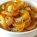 Here is what you need for slow cooker maple glazed caramelized onions: - 4 large yellow onions, thinly sliced - 1/4 cup unsalted butter - 1/4 cup pure maple syrup - 1 teaspoon fresh thyme leaves (or 1/2 teaspoon dried thyme) - 1/2 teaspoon salt - 1/4 teaspoon black pepper - 1 tablespoon balsamic vinegar - Pinch of red pepper flakes (optional) These ingredients form the base of your dish. The yellow onions bring a sweet flavor. Butter adds richness, while maple syrup gives a deep sweetness. Thyme adds a nice herbal note. Salt and pepper enhance all flavors, and balsamic vinegar adds a tangy kick. The red pepper flakes can give a bit of heat if you like. Keep these ingredients handy. They work together to create a rich, sweet, and savory treat. You can use these onions in many dishes, making them a great addition to your cooking toolkit. To make slow cooker maple glazed caramelized onions, follow these simple steps. - Melt butter in the slow cooker Start by setting your slow cooker to low. Add 1/4 cup of unsalted butter. Let it melt completely. - Add sliced onions and mix with butter Take 4 large yellow onions and slice them thinly. Add the onions to the melted butter. Stir them well so every slice gets coated. - Drizzle maple syrup and add seasonings Pour 1/4 cup of pure maple syrup over the onions. Then, sprinkle in 1 teaspoon of fresh thyme leaves, 1/2 teaspoon of salt, and 1/4 teaspoon of black pepper. If you like heat, add a pinch of red pepper flakes. - Stir mixture and cover slow cooker Mix everything together until it's well combined. Cover the slow cooker snugly so the flavors stay locked in. - Cook on low for 6-8 hours, stirring occasionally Let the onions cook for 6 to 8 hours. Stir them once in a while if you can. This helps them caramelize evenly. - Add balsamic vinegar before serving When the onions are soft and golden, stir in 1 tablespoon of balsamic vinegar. This adds a lovely tang that balances the sweetness. - Allow to cool slightly before serving or storing Let the onions cool for a few minutes before you serve them. If you have leftovers, store them in an airtight container. These steps will help you create a sweet and savory delight that enhances many dishes. Enjoy! For the best flavor, use low heat. Cooking slowly brings out the natural sweetness in onions. This method takes time but yields rich, golden results. Stir the onions every now and then. This helps them cook evenly, ensuring no burnt bits. Taste your mixture while cooking. You might want to tweak the seasoning to fit your taste. Add a pinch more salt or a dash more maple syrup if you like. You can use these onions in many ways. They make a great topping for burgers. The sweet and savory flavor adds a gourmet touch. You can also pair them with grilled meats. The richness complements the smoky flavors perfectly. Another idea is to serve them on toasted bread with cheese. This creates a simple but fancy appetizer. The options are endless! {{image_2}} You can easily change the taste of your caramelized onions. Here are some ideas: - Adding garlic for extra aroma: Mince a few cloves and stir them in with the onions. Garlic adds a rich smell and flavor. - Using different herbs like rosemary or sage: Fresh herbs can bring new life to your dish. Try adding rosemary for a piney taste or sage for a warm, earthy note. - Experimenting with different sweeteners: If you want a change, use honey or agave syrup instead of maple syrup. Each sweetener gives a unique flavor. If you want to try new ways to cook your onions, consider these methods: - Stovetop caramelization: Heat a pan over low heat. Add butter and onions. Stir often. This method takes less time, about 30 minutes. - Instant Pot version: Use the sauté setting to cook onions with butter for 10 minutes. Then, add maple syrup and seasonings. Seal the lid and cook on high pressure for 15 minutes. This method is quick and still tasty. - Storing in airtight containers: After your onions cool, place them in airtight containers. This helps keep them fresh and flavorful. Make sure to seal the lids tightly to avoid air getting in. - Refrigeration duration and tips: Store your maple glazed caramelized onions in the fridge for up to one week. If you want to use them later, label the container with the date. This way, you won't forget when you made them. - Freezing options for longer storage: For longer storage, you can freeze the onions. Place them in freezer-safe bags or containers. Remove as much air as you can before sealing. They can last for about three months in the freezer. When ready to use, thaw in the fridge overnight or reheat directly from frozen. How do I know when the onions are done? You can tell the onions are done when they are soft and brown. They should look shiny and have a sweet smell. A good rule is to cook them for 6-8 hours on low. Stir them occasionally if you can. Can I use different types of onions? Yes, you can use different onions! Yellow onions are great, but you can also use sweet onions or red onions. Each type gives a unique taste. Sweet onions add more sugar, while red onions add a nice color. What dishes pair well with caramelized onions? Caramelized onions are very versatile. They taste great on burgers, grilled meats, and sandwiches. You can also serve them on toasted bread with cheese for a tasty snack. They even work well in pasta dishes! How long do they last in the refrigerator? Caramelized onions last about one week in the fridge. Store them in an airtight container for the best results. Make sure they cool down before you put them in the fridge. Can I make this recipe vegan? Yes, you can make this recipe vegan! Simply replace the butter with a plant-based option like coconut oil or vegan butter. The rest of the recipe stays the same. Enjoy your tasty, vegan caramelized onions! In this blog post, you learned how to make slow cooker maple glazed caramelized onions. We covered the key ingredients, easy steps for cooking, and tips to perfect the flavor. You can even customize this dish with different herbs and toppings. Remember, cooking low and slow brings out the best taste. Use these onions on burgers or toast for a special treat. Enjoy experimenting with your own ideas and share them! These onions are sure to impress.