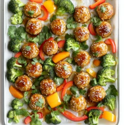 - 1 pound ground chicken - 1/2 cup breadcrumbs (preferably panko) - 1/4 cup green onions, finely chopped - 1 clove garlic, minced - 1 teaspoon ginger, grated - 1 tablespoon soy sauce (low sodium) - 1 tablespoon sesame oil - 1 large egg, beaten - Salt and pepper, to taste - 1 cup bell peppers, chopped (mixed colors) - 1 cup broccoli florets - 1/4 cup teriyaki sauce (store-bought or homemade) - Sesame seeds, for garnish - Fresh cilantro, for garnish Ground chicken is key for these meatballs. It stays moist and tender. I like using panko breadcrumbs. They add crunch and help the meatballs hold their shape. Fresh ginger and garlic bring great flavor. They also make the dish smell amazing when cooking. Low sodium soy sauce keeps it from being too salty. Sesame oil adds a rich, nutty taste. Using fresh veggies like bell peppers and broccoli makes the meal colorful and healthy. Teriyaki sauce gives a sweet and savory glaze that ties everything together. You can swap ground chicken for ground turkey if you prefer. It offers a similar texture with slightly less fat. If you don't have panko, regular breadcrumbs work well, but they won't be as crunchy. Green onions can be replaced with chopped onions or shallots if needed. For a vegetarian twist, try using mushrooms or tofu instead of meat. If you want a gluten-free option, use gluten-free breadcrumbs and tamari instead of soy sauce. You can also customize the veggies. Carrots, snap peas, or zucchini would taste great too! To kick off this tasty meal, first, preheat your oven to 400°F (200°C). While that warms up, grab a large mixing bowl. Here, you’ll combine the ground chicken, breadcrumbs, green onions, garlic, ginger, soy sauce, sesame oil, beaten egg, salt, and pepper. Mix these ingredients gently with your hands until just combined. Don't overwork the meat; this keeps the meatballs tender. Next, shape the mixture into small meatballs, about 1-inch wide. Place them on a sheet pan lined with parchment paper. This makes cleanup easy later. Now, chop your bell peppers and broccoli florets. Scatter these around your meatballs on the pan. Drizzle a bit of sesame oil over the veggies and sprinkle with salt and pepper. Now that everything is prepped, it’s time to bake. Slide the sheet pan into your preheated oven. Bake for 15 to 20 minutes. You want the internal temperature of the meatballs to hit 165°F (74°C) for safety. The veggies should become tender and vibrant during this time. Once the meatballs and veggies are done, take the pan out of the oven. Brush a good amount of teriyaki sauce over the cooked meatballs. Toss the veggies gently in the sauce so they get a nice coating as well. Now, pop the pan back in the oven and broil it for an extra 2 to 3 minutes. This step caramelizes the teriyaki sauce and boosts the flavor. Keep a close watch to avoid burning. When you take it out, sprinkle sesame seeds and fresh cilantro on top. Serve hot over rice or quinoa for a complete meal. Enjoy! To make great meatballs, start with the right mix. Use ground chicken and panko breadcrumbs. Panko makes the meatballs light and fluffy. Mix gently. Over-mixing can make them tough. Aim for small meatballs, about one inch wide. This size helps them cook evenly. Lastly, always check the internal temperature. It should reach 165°F (74°C) for safety. For the best veggies, chop them into bite-sized pieces. I love using bright bell peppers and fresh broccoli. They add color and crunch. Toss them with a bit of sesame oil. This helps them roast well. Season with salt and pepper to enhance their taste. Spread the veggies evenly on the sheet pan. This ensures they cook at the same time as the meatballs. Applying the teriyaki sauce is key to flavor. After baking, brush the sauce over the meatballs. This gives them a shiny, tasty glaze. Toss the veggies in the sauce too. They soak up the flavor and taste great. For a final touch, broil the pan for a few minutes. This caramelizes the sauce and adds depth. Keep an eye on it to avoid burning. Enjoy the results! {{image_2}} You can easily swap ingredients for this dish. Use ground turkey instead of chicken. It gives a leaner option. If you lack panko, regular breadcrumbs work fine. For a gluten-free choice, use almond flour or gluten-free breadcrumbs. You can skip green onions and replace them with finely diced shallots. Want a kick? Add some red pepper flakes to your meatball mix. Serve these meatballs over steamed rice or quinoa for a hearty meal. You can also try them in lettuce wraps. This adds a crisp, fresh touch. Pair them with a side of edamame for added protein. If you want a light meal, serve with a green salad dressed in sesame vinaigrette. You can cook these meatballs in several ways. Try pan-frying them for a crispy outer layer. Use a non-stick skillet over medium heat for about 10-12 minutes. You can also grill the meatballs for a smoky flavor. If you have an air fryer, that’s another great way. Set it to 400°F and cook for about 10-12 minutes. Each method gives a unique taste! Store your leftover sheet-pan teriyaki chicken meatballs in an airtight container. Keep them in the fridge for up to three days. If you want to maintain freshness, let them cool before sealing. This helps prevent condensation, which can make the meatballs soggy. To reheat, place the meatballs on a plate. Cover them with a damp paper towel to keep moisture in. Heat in the microwave for about 1-2 minutes on high. For an oven option, preheat to 350°F (175°C) and bake for about 10 minutes. This method keeps the meatballs nice and juicy. You can freeze the meatballs for later use. First, let them cool completely. Then, arrange them in a single layer on a baking sheet. Freeze until solid, about 1-2 hours. Once frozen, transfer them to a freezer-safe bag. They can last up to three months in the freezer. To cook, thaw overnight in the fridge and reheat as mentioned above. You can tell when your meatballs are done by checking their temperature. Use a meat thermometer to ensure they reach 165°F (74°C). If you don’t have a thermometer, cut one open. The inside should look white and not pink. The outside will also have a nice brown color. The meatballs should feel firm but springy to the touch. Yes, you can use ground turkey in place of chicken. The flavor will change slightly, but it will still taste great. Ground turkey is leaner. You may need to add a little more seasoning. If you choose turkey, aim for a mix that has some fat for moisture. This way, the meatballs stay juicy. Teriyaki meatballs pair well with many sides. Here are some tasty options: - Steamed rice: White or brown rice works well. - Quinoa: A healthy grain that adds protein. - Stir-fried vegetables: Mix your favorite veggies with a light sauce. - Salad: A fresh salad can add a nice crunch. - Noodles: Try serving them over soba or udon noodles. These sides make your meal colorful and filling, enhancing your dining experience. Enjoy! This post covered all you need for making teriyaki meatballs. We discussed key ingredients, how to prepare them, and cooking tips. I shared ways to switch ingredients if you’re out of something and how to store your meatballs for later. Remember, practice makes perfect. With these steps, you can create a tasty meal. Enjoy experimenting and making your dish unique! Happy cooking!