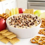 To make this tasty dip, you need: - 1 cup all-purpose flour - 1/2 cup unsalted butter, softened - 1/2 cup brown sugar, packed - 1/4 cup granulated sugar - 1 teaspoon vanilla extract - 1/4 teaspoon salt - 1/2 cup cream cheese, softened - 1/2 cup mini chocolate chips - Assorted dippers like graham crackers, apple slices, or pretzels For the best taste, I recommend these brands: - King Arthur Flour for the all-purpose flour. - Challenge Butter for unsalted butter. - Domino Sugar for both brown and granulated sugar. - Philadelphia Cream Cheese for a rich texture. Want to make your dip even better? Try adding: - 1/4 cup chopped nuts, like walnuts or pecans. - A sprinkle of sea salt on top for contrast. - A dash of cinnamon for a warm flavor twist. Feel free to mix and match these ingredients to fit your taste! First, gather your ingredients. You need: - 1 cup all-purpose flour - 1/2 cup unsalted butter, softened - 1/2 cup brown sugar, packed - 1/4 cup granulated sugar - 1 teaspoon vanilla extract - 1/4 teaspoon salt - 1/2 cup cream cheese, softened - 1/2 cup mini chocolate chips - 1/4 cup chopped nuts (optional) - Assorted dippers (graham crackers, apple slices, pretzels) Make sure everything is at room temperature. This helps with mixing. Start with a large bowl. Add the softened butter, brown sugar, and granulated sugar. Beat them with an electric mixer on medium speed. Mix until creamy. This should take about 1-2 minutes. Next, add the softened cream cheese and vanilla extract to the bowl. Mix until smooth and fluffy. It should look light and airy. Now, slowly add the all-purpose flour and salt. Mix on low speed until combined. Be careful not to overmix. You want it smooth but not tough. Once combined, fold in the mini chocolate chips and chopped nuts using a spatula. Make sure they are evenly mixed in. Transfer the dip to a serving bowl. Cover it tightly with plastic wrap. Chill in the fridge for at least 30 minutes. This helps the flavors mix well. When ready to serve, place the bowl on a plate. Arrange assorted dippers like graham crackers, apple slices, or pretzels around it. Enjoy your delicious dip! When making this dip, avoid using raw flour. Always bake it first to kill any germs. Don't rush the mixing. Cream the butter and sugars well for a fluffy dip. Watch out for overmixing once you add the flour. This makes the dip dense. Lastly, don't forget to chill the dip! It really helps the flavors come together. To get that smooth and creamy texture, make sure your butter and cream cheese are soft. This helps everything blend well. Mix slowly when adding flour to avoid lumps. If the dip is too thick, add a splash of milk. This will help it reach the right consistency. If you want it lighter, beat in some whipped cream before serving. Serve this dip chilled for the best flavor. After mixing, chill it for at least 30 minutes. This allows the flavors to blend nicely. If it sits out too long, it can get too warm. Keep it in the fridge until you are ready to enjoy. This dip pairs well with cold dippers like apple slices or graham crackers. {{image_2}} You can switch up this dip in fun ways. Try adding peanut butter for a nutty twist. Just mix in 1/4 cup of creamy peanut butter when you add the cream cheese. You can also use different flavored chips. White chocolate or dark chocolate chips work well. For a minty flavor, add a few drops of mint extract instead of vanilla. Each of these changes will give your dip a new taste. If you have allergies, you can easily adjust the recipe. Use almond flour or coconut flour instead of all-purpose flour. This keeps it safe for gluten-free eaters. For dairy-free options, use vegan butter and non-dairy cream cheese. If you can't have nuts, skip them or use seeds like sunflower seeds for crunch. Always check labels to ensure your ingredients are safe. When it comes to dippers, the sky's the limit! Try using graham crackers, apple slices, or pretzels. You can also serve the dip with fruit like strawberries or bananas. For something crunchy, tortilla chips are a great choice too. Mix and match dippers to keep it fun. You might even discover a new favorite! To store any leftover dip, place it in an airtight container. Make sure to cover it well. This keeps the dip from drying out. It will stay fresh in your fridge for about three days. When you're ready to eat, just scoop some out. You can serve it cold or let it warm up a bit. If you want to save the dip for later, freezing works great. Transfer the dip into a freezer-safe container. Make sure to leave some space at the top because it will expand. Seal tightly and label it with the date. This dip can last for up to two months in the freezer. When you are ready to eat it, let it thaw overnight in the fridge. To keep your dip fresh, avoid double-dipping with dippers. If you use a utensil, always use a clean one. This keeps bacteria from getting into the dip. If you notice any changes in smell or texture, it’s best to toss it out. Enjoy this yummy treat while it’s at its best! Yes, this dip is safe to eat. We use heat-treated flour to avoid any risk. Most people use regular flour, but it can cause issues if not cooked first. Eating raw flour can lead to stomach problems. To stay safe, always heat treat your flour. Simply bake it at 350°F for five minutes. Let it cool before mixing it into your dip. Yes, you can use gluten-free flour. The dip will still taste great! Look for a good gluten-free blend. Make sure it works well for baking. Some brands mix well and give a nice texture. Keep in mind that the taste may vary a bit. But it will still be delicious! This dip lasts about five days in the fridge. Store it in an airtight container. This keeps it fresh and tasty. If you want to enjoy it longer, you can freeze it. Just make sure to let it thaw before serving. You have many options for dippers! Here are some favorites: - Graham crackers - Apple slices - Pretzels - Vanilla wafers - Carrot sticks - Strawberries Feel free to mix and match! Each dipper adds its own flavor and fun. Enjoy exploring your options! In this post, we covered essential ingredients, step-by-step instructions, and helpful tips for making chocolate chip cookie dough dip. We also explored variations, storage info, and answered common questions. By following these guidelines, you can create a tasty treat that impresses everyone. Remember, enjoy your dip with fun dippers and share it at gatherings. With these easy steps, you’ll have a delicious dip that everyone will love!