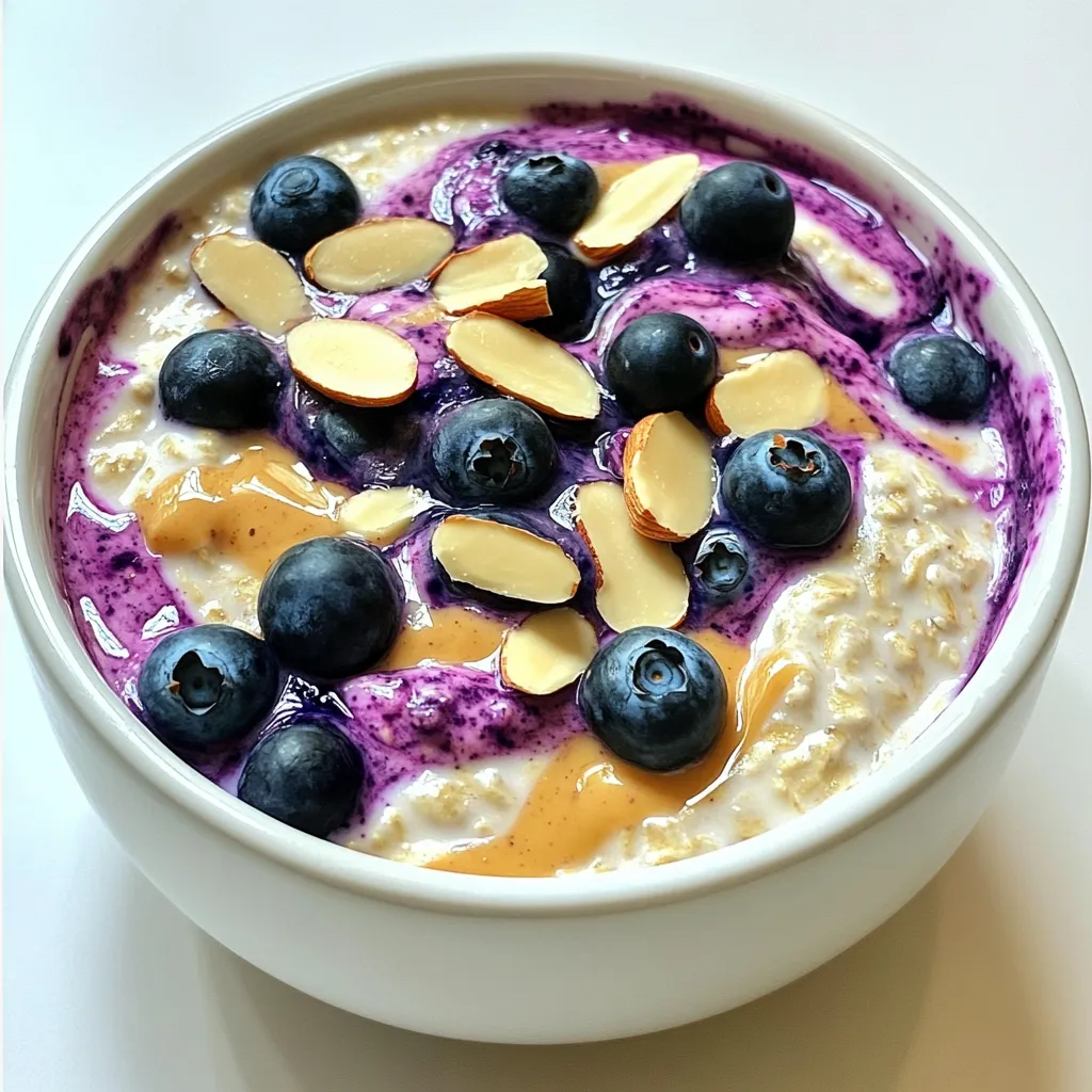To make blueberry almond overnight oats, gather these ingredients: - 1 cup rolled oats - 1 cup almond milk (or any milk alternative) - 1/2 cup plain Greek yogurt (or dairy-free alternative) - 1 cup fresh blueberries (plus extra for topping) - 1/4 cup almond butter - 2 tablespoons maple syrup (or honey) - 1/2 teaspoon vanilla extract - 1 tablespoon chia seeds - A pinch of salt - Sliced almonds for garnish If you lack any ingredients, don’t worry! Here are some swaps: - Use oats from gluten-free sources if needed. - Substitute almond milk with coconut or oat milk. - For yogurt, try a dairy-free option like soy or coconut yogurt. - Swap fresh blueberries for frozen ones if that’s what you have. - Use peanut butter instead of almond butter for a different taste. - Maple syrup can be replaced with agave syrup or honey. These oats offer a tasty blend of nutrients. Here’s a quick look: - Calories: About 400 per serving - Protein: Roughly 15 grams - Fat: Around 15 grams - Carbohydrates: About 60 grams - Fiber: Approximately 10 grams The oats provide energy, while yogurt adds protein. Blueberries are rich in vitamins and antioxidants. This meal is filling and good for your health! Start by taking a mixing bowl. Add 1 cup of rolled oats. Pour in 1 cup of almond milk. Next, add 1/2 cup of plain Greek yogurt. Mix these ingredients well. You want them to blend smoothly. Then, add 1/2 teaspoon of vanilla extract. Stir again until it all comes together. Now, it's time for the fun part! Add 1/4 cup of almond butter. It gives the oats a creamy texture. Then, pour in 2 tablespoons of maple syrup for sweetness. Add 1 tablespoon of chia seeds as well. Don’t forget a pinch of salt to enhance the flavors. Mix everything until the almond butter is fully combined. Gently fold in 1 cup of fresh blueberries. Be careful not to crush them while mixing. Once your mixture is ready, divide it into two jars. Choose jars with tight lids for best results. Cover them and place them in the fridge. Let them chill overnight or for at least 4 hours. When you are ready to eat, stir the oats. If they seem too thick, add a splash of almond milk. Top with extra blueberries and sliced almonds. Enjoy your tasty meal! To get the best texture for your blueberry almond overnight oats, use rolled oats. They soak up liquid well and stay soft. If you want a creamier mix, use more yogurt or almond milk. You can also add chia seeds for a thicker feel. Letting the oats sit overnight helps them soften and blend flavors. You can boost the flavor of your overnight oats in simple ways. Add more vanilla extract for sweetness. A dash of cinnamon will warm up the taste. If you want a nutty kick, sprinkle in some chopped almonds on top. Fresh blueberries add tartness, while maple syrup brings sweetness. Use these tips to create a mix that suits your taste. Overnight oats are perfect for meal prep. You can make a batch for the week. Just follow the recipe and divide it into jars. Store them in the fridge for up to five days. In the morning, grab a jar and go. For variety, switch the fruits or nuts each week. This keeps breakfast fun and tasty! {{image_2}} You can mix up your blueberry almond overnight oats in fun ways. Try adding a spoonful of cocoa powder for a chocolate twist. A sprinkle of cinnamon gives warmth and spice. You can also swap almond butter for peanut butter for a nutty flavor. If you want a fruity burst, mix in strawberries or raspberries. To make these oats vegan, simply use almond milk and a dairy-free yogurt. You can also choose a maple syrup instead of honey. For a gluten-free option, ensure your rolled oats are certified gluten-free. This way, everyone can enjoy this tasty meal without worries. In summer, fresh peaches or ripe cherries work well with these oats. In fall, chopped apples and a dash of cinnamon create a cozy dish. Winter brings citrus fruits like oranges or grapefruits for a refreshing touch. Using seasonal fruits keeps your breakfast fun and exciting! To store overnight oats, use jars or bowls with tight lids. Divide the mixture into two containers. Make sure to cover them well. This keeps the oats fresh and tasty. Place them in the fridge right after making. The cold helps the oats soak up the liquid. Overnight oats stay fresh for about 3 to 5 days in the fridge. The oats may get thicker over time. If they do, just add a splash of almond milk. This helps to bring back the creamy texture. Always check for any off smells or changes in color before eating. You can eat overnight oats cold, but some like them warm. To heat, place the oats in a bowl. Microwave them for about 30 to 60 seconds. Stir well, and check the temperature. If they are too thick, add a bit more almond milk. Top with extra blueberries and sliced almonds for a fresh touch. Enjoy your easy and tasty meal! Yes, you can use frozen blueberries. They work well in overnight oats. Just remember, they may make your oats a bit wetter. I recommend you thaw them before mixing. This way, they blend nicely without adding too much moisture. You can also add them just before serving for a cool touch. Overnight oats can last up to five days in the fridge. They stay fresh and tasty if stored in a sealed jar. Just give them a stir before eating. If they seem too thick, add a splash of almond milk to loosen them up. Absolutely! You can skip the yogurt. Use more almond milk instead. If you want creaminess, try adding mashed banana or extra almond butter. Both options keep your oats rich and delicious without dairy. In this article, we covered how to make delicious overnight oats. We looked at the key ingredients, how to prepare them, and helpful tips. I shared flavor ideas and ways to modify the recipe for diets like vegan and gluten-free. You can also store your oats easily for long-lasting freshness. Remember, you can mix all kinds of flavors for variety. Overnight oats are a simple, tasty, and healthy meal choice. Now, it's time for you to try making them your way!