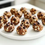 - 1 cup rolled oats - ½ cup pumpkin puree - ¼ cup almond butter (or other nut butters) - ¼ cup honey or maple syrup - 2 tablespoons unsweetened cocoa powder - 1 tablespoon instant coffee granules - 1 teaspoon vanilla extract - ½ teaspoon cinnamon - A pinch of salt - ¼ cup mini chocolate chips - ¼ cup chopped nuts or seeds When making No Bake Mocha Pumpkin Energy Bites, you'll need a mix of key ingredients. The rolled oats form the base. They offer a chewy texture and are full of fiber. Pumpkin puree gives a nice flavor and is packed with nutrients. Almond butter adds healthy fats and creaminess. Honey or maple syrup sweetens the bites naturally. For flavor, cocoa powder brings a rich taste. Instant coffee granules add a coffee kick, perfect for mocha lovers. Vanilla extract adds warmth, while cinnamon gives a hint of spice. A pinch of salt enhances all the flavors. You can also add mini chocolate chips for extra sweetness or chopped nuts for crunch. These optional add-ins are fun and let you customize your bites. Mix and match to find your favorite combination! - First, grab a large mixing bowl. - Combine 1 cup rolled oats, ½ cup pumpkin puree, ¼ cup almond butter, and ¼ cup honey. - Stir the mixture until all ingredients blend well. - Next, add 2 tablespoons unsweetened cocoa powder, 1 tablespoon instant coffee granules, and 1 teaspoon vanilla extract. - Don’t forget ½ teaspoon cinnamon and a pinch of salt. - Mix everything until the dough is smooth and even. - If you want, fold in ¼ cup mini chocolate chips and ¼ cup chopped nuts for more texture. - Now, refrigerate the mixture for 15-20 minutes. - This helps it firm up, making it easier to roll. - After chilling, take it out of the fridge. - Use your hands to roll the mixture into balls about 1 inch wide. - Place the rolled bites on a baking sheet lined with parchment paper. - You can eat them right away or refrigerate them for an hour for a firmer bite. - Store any leftovers in an airtight container in the fridge for up to one week. To make the best No Bake Mocha Pumpkin Energy Bites, thorough mixing is key. When you mix the oats, pumpkin puree, and nut butter, aim for an even blend. This ensures every bite has the same yummy flavor. You can also adjust the sweetness to your taste. Use honey or maple syrup, depending on what you prefer. Want to make these bites nut-free? Substitute almond butter with sunflower seed butter. This way, you still get a creamy texture. You can also try different sweeteners. Agave syrup or coconut sugar can change the taste and sweetness level, so feel free to experiment. These energy bites pair great with coffee or tea. They make a perfect afternoon snack. If you need a quick boost, grab one for on-the-go energy. They are also great for meal prep! Make a batch and enjoy them throughout the week. {{image_2}} - Calories per serving: Each energy bite has about 80 calories. If you eat two, that's 160 calories. - Key vitamins and minerals contained: These bites are rich in vitamin A from pumpkin. They also provide fiber from oats, and healthy fats from almond butter. - Boost of energy from oats and pumpkin: Oats give you quick energy. Pumpkin adds vitamins and fiber. Together, they make a great snack before or after workouts. - Healthy fats from nut butter: Nut butter provides good fats. These fats help keep you full and support brain health. - Adjustments for dietary restrictions: You can make these bites gluten-free by using gluten-free oats. For a vegan option, swap honey for maple syrup and choose a plant-based nut butter. To keep your No Bake Mocha Pumpkin Energy Bites fresh, use an airtight container. This will prevent moisture from getting in. I suggest using glass or BPA-free plastic. Always ensure the lid is sealed tightly. In the refrigerator, your energy bites last about one week. If you want to keep them longer, freezing is a great option. You can freeze them for up to three months. Just place them in a freezer-safe bag. Make sure to remove excess air to avoid freezer burn. Check for changes in smell or texture. If they smell off or feel sticky, it’s time to toss them. You might also notice mold. If you see any, don’t eat them. Always trust your senses when it comes to food safety. Yes, you can make these energy bites vegan. For a vegan sweetener, you can use maple syrup instead of honey. Almond butter is a great choice, but you can also use peanut butter or sunflower seed butter. Both options work well and keep the bites delicious. These energy bites last about one week in the fridge. Store them in an airtight container. To keep them fresh, avoid leaving them out at room temperature for too long. If you want to keep them longer, you can freeze them. Just make sure to thaw them before eating. Yes, you can replace cocoa powder if you want. Try using carob powder for a sweeter taste. You can also skip the cocoa and use extra spices like nutmeg for a different flavor. Just keep in mind that it may change the taste a bit. These No Bake Mocha Pumpkin Energy Bites are easy and fun to make. We mixed wholesome ingredients like oats, pumpkin puree, and almond butter for a tasty treat. Adding cocoa, coffee, and cinnamon gives them a rich flavor. You can customize them with chocolate chips or nuts. Remember to store these bites well for freshness. They fit many diets, too, like vegan or gluten-free. These bites not only taste good but also provide energy and nutrients. Enjoy them as snacks or with your favorite drink, and get ready to feel great!