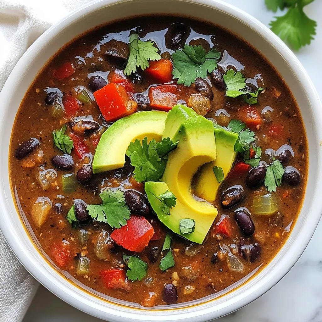 - 2 cups cooked black beans (or 1 can, rinsed and drained) - 1 medium onion, diced - 2 cloves garlic, minced - 1 jalapeño, minced (seeded for less heat) - 1 red bell pepper, diced - 1 tablespoon olive oil - 2 teaspoons ground cumin - 1 teaspoon smoked paprika - 1-2 chipotle peppers in adobo sauce, chopped (adjust to taste) - 4 cups vegetable broth - 1 can (14 oz) diced tomatoes - 1 tablespoon lime juice - Salt and black pepper to taste - Fresh cilantro, chopped (for garnish) - Avocado slices (for garnish) You can swap the canned black beans for dried beans. Just soak them overnight and cook until soft. If you don't have a jalapeño, use a green bell pepper for a milder taste. For a smoky flavor, smoked paprika is key, but you can use regular paprika too. If chipotle peppers are too spicy, use less or skip them entirely. You can add extra lime juice for more zest or use lemon as a substitute. When choosing your vegetables, look for firm onions with smooth skin. The garlic should feel heavy with no soft spots. For the bell peppers, pick ones that are bright and firm. A fresh jalapeño should be shiny, with no wrinkles. Check your canned goods; they should be free from dents or bulges. This ensures you have the best flavors for your spicy chipotle black bean soup. {{ingredient_image_1}} Making Spicy Chipotle Black Bean Soup is easy. You start by cooking onions, peppers, and garlic. Then, you add spices and let everything simmer. Finally, you can blend it for creaminess or leave it chunky. 1. Heat oil: Pour olive oil into a large pot. Set the heat to medium. 2. Sauté veggies: Add diced onion, bell pepper, and jalapeño. Cook for 5-7 minutes until the onion is clear. 3. Add garlic: Mix in minced garlic and cook for 1 more minute. 4. Stir in spices: Add cumin, smoked paprika, and chipotle peppers. Cook for 2 minutes to bring out the flavors. 5. Combine ingredients: Toss in black beans, diced tomatoes, and vegetable broth. Stir well. 6. Simmer: Bring the soup to a boil, then lower the heat. Let it simmer for 20-25 minutes. 7. Blend (optional): If you want a smooth soup, use an immersion blender. If not, keep it chunky. 8. Finish: Add lime juice, and season with salt and black pepper. Adjust thickness with more broth if needed. 9. Serve: Ladle into bowls and top with cilantro and avocado slices for a fresh touch. Blending the soup gives it a creamy texture. You can use an immersion blender right in the pot. If you want a very smooth soup, blend it in batches in a regular blender. Just be careful when handling hot soup! If you prefer a chunkier soup, skip blending and enjoy the textures. To boost the flavor of your spicy chipotle black bean soup, try adding a splash of lime juice. Lime adds a bright taste that lifts the rich flavors. Fresh herbs like cilantro can also make a big difference. Sprinkle chopped cilantro on top before serving. You can also add a swirl of sour cream for creaminess. If you want more heat, add extra chipotle peppers. Start with one and taste before adding more. If the soup is too spicy, add a bit of sugar or honey. This will balance the heat. You can also add dairy, like yogurt, to mellow the spice. Remember, you control the heat! Serve your soup hot in deep bowls. Garnish with avocado slices and cilantro for color. A lime wedge on the side adds a zesty touch. This soup pairs well with crusty bread or corn tortillas. You can also serve it with a simple salad for a complete meal. Enjoy your cozy, flavorful dish! Pro Tips Adjust the Heat: If you prefer a milder soup, remove the seeds from the jalapeño and use only one chipotle pepper. You can always add more heat later if desired! Make it Creamy: For a creamier texture, blend the soup with an immersion blender for a few seconds. If you like it chunky, skip this step and enjoy the whole ingredients. Fresh Garnishes: Enhance the flavor with fresh toppings like crumbled queso fresco or a dollop of sour cream. These will add a nice creaminess and contrast to the spiciness. Storage Tips: Store leftovers in an airtight container in the fridge for up to 5 days. This soup also freezes well, making it a great make-ahead meal! {{image_2}} This soup is perfect for vegetarians and vegans. It already uses black beans and vegetable broth, making it plant-based. You can add more veggies, like corn or zucchini, for extra flavor. For a creamier texture, use coconut milk instead of broth. Both options keep it hearty and delicious. You can easily boost the protein in this soup. If you like chicken, add cooked, shredded chicken. Just stir it in before serving. For a plant-based option, try tofu. Use firm tofu, cube it, and pan-fry until golden before adding it. Both options make the soup even more filling. Feel free to switch up the spices! If you want more heat, add cayenne pepper or red pepper flakes. For a different flavor, try adding oregano or cilantro. You can also use fresh herbs instead of dried for a brighter taste. Each change will give your soup a new twist! After you enjoy your spicy chipotle black bean soup, let it cool. Place leftovers in an airtight container. Store in the fridge for up to four days. This helps keep the flavors fresh and tasty. Want to save some for later? You can freeze this soup! Use freezer-safe containers. Leave some space at the top, as soup expands when frozen. It lasts up to three months in the freezer. When you’re ready to eat, just thaw it in the fridge overnight. To reheat, pour the soup into a pot. Heat on low to medium heat. Stir often to prevent sticking. If it seems thick, add a splash of broth or water. You can also use a microwave. Heat in short intervals, stirring in between. Enjoy every delicious bite! Chipotle peppers are smoked jalapeños. They add a deep, spicy flavor to dishes. You find them in adobo sauce, which blends spices and tomatoes. This sauce adds warmth and richness to your soup. I love using them to give a kick to the meal. Adjust the number you use based on your heat preference. Yes, you can use dried beans. They require more time to cook. First, soak them overnight in water. The next day, cook them in boiling water until soft. This can take one to two hours, so plan ahead. Canned beans save time and are just as tasty. Rinse and drain them before adding to your soup. This soup is naturally gluten-free. All the ingredients are safe for gluten-free diets. Just check labels on canned goods. Some brands add fillers that may contain gluten. Use vegetable broth that is certified gluten-free to ensure safety. Your soup will be flavorful and safe for everyone. We covered key ingredients for your dish, including options for substitutions and tips for choosing fresh items. I shared a clear, step-by-step cooking guide and helpful blending techniques. You learned ways to enhance flavor, adjust spice levels, and saw various serving ideas. I also highlighted options for vegetarians and offered ways to store and freeze leftovers. In closing, these tips can help you create a delicious meal, no matter your skill level. Enjoy your cooking!