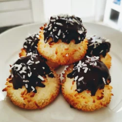 - 2 ½ cups shredded coconut (unsweetened) - 1 cup sweetened condensed milk - 1 teaspoon vanilla extract - ½ teaspoon almond extract - 1 cup semi-sweet chocolate chips - ¼ teaspoon sea salt - 2 large egg whites - 1 tablespoon coconut oil (for melting chocolate) Gather these ingredients before you start. Using unsweetened coconut helps balance the sweetness from the condensed milk. The vanilla and almond extracts add great flavor depth. The semi-sweet chocolate chips will give a rich finish to each macaroon. Keep the sea salt in mind; it enhances the sweet taste. Remember to use large egg whites for the right texture. Coconut oil helps the chocolate melt smoothly, making it easy to coat the macaroons. Each ingredient plays a role in creating this delightful treat. Enjoy the process of baking! {{ingredient_image_1}} 1. Preheat your oven to 325°F (160°C). Line a baking sheet with parchment paper. This helps the macaroons not stick. 2. In a large bowl, combine 2 ½ cups shredded coconut, 1 cup sweetened condensed milk, 1 teaspoon vanilla extract, ½ teaspoon almond extract, and ¼ teaspoon sea salt. Mix well until all ingredients blend together. 3. In a separate bowl, whip 2 large egg whites. Beat them until they form stiff peaks. This step makes your macaroons light and fluffy. 4. Gently fold the whipped egg whites into the coconut mixture. Be careful not to deflate the egg whites. Mix until just combined for the best texture. 5. Use a tablespoon or a small cookie scoop to form the mixture into mounds. Place them on the prepared baking sheet, leaving space between each macaroon. 6. Bake for 20-25 minutes. Look for golden brown tops. Once done, take them out and let them cool completely on the baking sheet. 1. To melt the chocolate, use 1 cup semi-sweet chocolate chips and 1 tablespoon coconut oil. Place them in a microwave-safe bowl. 2. Microwave in 30-second increments. Stir between each increment until smooth. This helps avoid burning the chocolate. 3. Once the macaroons are cool, dip the bottoms into the melted chocolate or drizzle chocolate over the tops. This adds a nice touch and flavor. 4. Place the dipped macaroons back on the parchment paper. Let the chocolate set at room temperature or in the fridge for quicker results. Enjoy your tasty treat! To make great macaroons, start by whipping the egg whites. Beat them until they form stiff peaks. This step adds lightness to your treats. Soft, fluffy macaroons come from well-whipped egg whites. Next, focus on folding. Gently add the whipped egg whites to the coconut mix. Use a spatula and fold carefully. This keeps the air in the egg whites. Do not stir too hard or too fast. You want to keep that airy texture for your macaroons. Baking time is key to avoid sticking. Line your baking sheet with parchment paper. This helps the macaroons lift off easily. Make sure they have space between them. They will spread a bit while baking. Look for the signs of doneness. The tops should turn golden brown. If they are too light, they may be undercooked. Allow them to cool on the sheet. This helps them set and stay firm. Pro Tips Use Fresh Coconut: For an even richer flavor, try using fresh shredded coconut instead of dried. It will enhance the texture and taste of your macaroons. Perfect Egg Whites: Ensure your mixing bowl is free of any grease before whipping the egg whites. This will help them achieve maximum volume and stability. Chocolate Tempering: If you want a glossy finish on your chocolate, consider tempering it before dipping. This gives a professional touch and helps the chocolate set better. Storage Tips: Keep macaroons in an airtight container at room temperature for up to a week. For longer storage, refrigerate them to maintain freshness. {{image_2}} You can easily change the flavor of your chocolate coconut macaroons. Adding spices like cinnamon or nutmeg can give them a warm twist. Just a pinch of either spice works wonders. If you want a richer taste, mix in some chocolate chunks or nuts. Chopped almonds or pecans add a nice crunch and depth. Coating your macaroons can enhance their look and flavor. You can dip them in white or dark chocolate for a sweet touch. Each type of chocolate brings a different taste. For a fun finish, try decorating with toppings. Crushed nuts or colorful sprinkles make your treats pop. They become more festive and inviting this way. To keep your chocolate coconut macaroons fresh, choose the right container. An airtight container works best. This keeps moisture out and flavor in. Glass or plastic containers both work well. Store your macaroons at room temperature for short-term use. They stay fresh for a few days this way. If you live in a warm area, consider refrigeration. It helps them stay firm and cool. Chocolate coconut macaroons last about one week at room temperature. If you want to save them longer, freezing is a great option. Wrap each macaroon in plastic wrap. Then, place them in a freezer bag. This method keeps them tasty for up to three months. When you're ready to enjoy, let them thaw at room temperature. No need to rush, as they taste great even after freezing! What are the differences between macaroons and macarons? Macaroons and macarons are not the same. Macaroons are made with coconut and are chewy. They often have a sweet taste. Macarons are French cookies made from almond flour. They are light, airy, and have fillings. Each has its charm, but they are quite different in taste and texture. Can I use sweetened coconut instead of unsweetened? Yes, you can use sweetened coconut. It will make your macaroons sweeter. If you prefer less sweetness, stick with unsweetened coconut. Adjust the sugar in your recipe if needed. This choice adds a fun twist to your treats. Is there a vegan option for these macaroons? Yes! You can make vegan macaroons. Replace the egg whites with aquafaba. Aquafaba is the liquid from canned chickpeas. It works well for whipping. Use the same amount as the egg whites. Your macaroons will still be tasty and fluffy. Why are my macaroons too dry or too wet? If your macaroons are too dry, you may not have enough moisture. Make sure to use enough sweetened condensed milk. If they are too wet, try adding a bit more coconut. Adjusting these ingredients helps get the right texture. How can I fix macaroons that spread too much? If your macaroons spread too much, check your oven temperature. Make sure it’s at 325°F (160°C). If it’s too low, your macaroons will spread. Also, try chilling the dough for 15 minutes before baking. This can help them keep their shape. You now have a clear path to make delicious macaroons. We covered key ingredients, step-by-step methods, tips for perfect texture, and ways to customize your flavor. Proper storage and answers to common questions help you succeed. Baking can be fun and rewarding. Keep experimenting with flavors and techniques. Enjoy the process, and you’ll create treats loved by many. Happy baking!