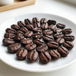 - 1 cup roasted espresso beans - 1 cup dark chocolate chips (at least 70% cocoa) - 1 tablespoon coconut oil - Sea salt, for sprinkling You can use different types of chocolate. Milk chocolate or white chocolate works well. If you want a sweeter taste, consider these options. For melting, you can swap coconut oil for butter or vegetable oil. Both work fine and give a nice texture. To enhance the flavor, think about adding a splash of vanilla extract. A dash of espresso powder can kick up the coffee taste too. These small changes make your snack even more special! {{ingredient_image_1}} To start, grab a microwave-safe bowl. Add 1 cup of dark chocolate chips and 1 tablespoon of coconut oil. Heat the bowl in the microwave for 30 seconds. Take it out and stir. Repeat this until the chocolate is smooth and melted. Stirring helps the chocolate melt evenly. Be patient and don't rush this step. If you heat it too long, the chocolate may burn. Now it's time to coat the beans. Add 1 cup of roasted espresso beans to the melted chocolate. Use a spatula or spoon to stir gently. Make sure each bean gets even coverage. This step is key for a tasty snack. When you lift a bean out, let the extra chocolate drip back into the bowl. This helps avoid clumps and keeps your beans looking neat. Next, prepare a baking sheet with parchment paper. Place the coated beans on the sheet. Avoid crowding them; give them space to set. Sprinkle a little sea salt on top while the chocolate is still soft. This adds a nice flavor boost. Now, put the baking sheet in the fridge. Chill them for about 30 minutes. This will help the chocolate harden evenly. After chilling, check for any clusters and break them apart. Store the beans in an airtight container. Enjoy your delicious snack! To get a great chocolate coating, timing is key. You want to remove the melted chocolate from the microwave when it is smooth but still warm. Let it cool slightly for about 5 minutes. This timing helps the chocolate coat the beans well without getting too thick. Make sure to stir the roasted espresso beans gently in the chocolate. This step ensures that every bean gets an even coat. If the beans aren’t coated well, some may taste plain. To keep your chocolate covered espresso beans fresh, store them in an airtight container. This keeps moisture out and maintains their crispness. Glass jars work well for this purpose. You can also use plastic containers with tight lids. Keep them away from heat and sunlight. A cool, dark place is best. If you want to store them for longer, the fridge can help. Just ensure the container is sealed tight to avoid any fridge odors. You can make your chocolate covered espresso beans even better! Try adding toppings like cocoa powder or crushed nuts. Sprinkle cocoa powder for a rich taste. Crushed nuts add crunch and depth. Pair your beans with drinks like coffee or dessert. They also go well with milk or dark chocolate drinks. Enjoy them as a snack or a sweet treat anytime. Pro Tips Choose Quality Beans: Use high-quality roasted espresso beans for the best flavor. The quality of the beans directly impacts the taste of your final product. Monitor Chocolate Temperature: Be careful not to overheat the chocolate. If it gets too hot, it can seize up and become unusable. Experiment with Chocolate Types: While dark chocolate is traditional, you can experiment with milk or white chocolate for different flavor profiles. Store Properly: Keep your chocolate-covered espresso beans in an airtight container at room temperature for optimal freshness. Avoid humidity to prevent the chocolate from getting sticky. {{image_2}} You can switch up the chocolate types for a new taste. Dark chocolate gives a rich flavor. Milk chocolate offers sweetness. White chocolate adds a creamy touch. Try mixing these chocolates for a unique treat. You can also infuse flavors into your beans. Peppermint gives a nice holiday twist. Adding orange zest brightens the taste. Both options make your snack fun and fresh. If you want a vegan snack, you can use vegan chocolate. Look for brands that are dairy-free. Coconut oil is a great substitute for butter. It melts well and adds a nice flavor. Also, ensure your espresso beans are vegan-approved. This way, you can enjoy a tasty treat without dairy. You can create seasonal chocolate-covered espresso beans. For the holidays, add cinnamon or nutmeg for warmth. In spring, use lemon zest for a bright taste. For summer, try coconut flakes for a tropical feel. Mixing flavors makes these beans fun for any occasion. You can impress guests with your creative ideas! You can store chocolate-covered espresso beans at room temperature for about two weeks. Keep them in a cool, dark place away from heat and sunlight. If you want to keep them longer, store them in the refrigerator. They can last up to a month there. Just make sure to place them in an airtight container to maintain freshness. Freezing chocolate-covered espresso beans is easy. First, place them in a single layer on a baking sheet. Put the sheet in the freezer until the beans are hard. After that, transfer them into a freezer-safe bag or container. This helps avoid clumping. When you want to enjoy them, take out the amount you need. Let them thaw in the fridge for a few hours. This keeps their texture nice and crunchy. Avoid thawing them at room temperature; it can make them soft and lose their crunch. To make chocolate covered espresso beans, start by melting dark chocolate chips and coconut oil together. Use a microwave-safe bowl for this. Heat the mixture in 30-second bursts, stirring until it is smooth. After melting, let the chocolate cool for about five minutes. Then, add your roasted espresso beans to the bowl and stir gently. Use a fork to lift each bean and let the excess chocolate drip off. Place the beans on a parchment-lined baking sheet. Sprinkle sea salt over them while the chocolate is still wet. Chill them in the fridge for about 30 minutes to harden. The best chocolate for coating espresso beans is dark chocolate with at least 70% cocoa. This chocolate offers a rich taste that pairs well with the strong flavor of espresso. You can also experiment with milk or white chocolate if you prefer a sweeter treat. Each type of chocolate brings its own unique flavor and sweetness to the beans. Yes, you can use other types of beans if you like. Roasted coffee beans work well for a similar flavor. You might also try roasting your own beans for a custom taste. However, keep in mind that espresso beans are denser and have a stronger flavor, which pairs perfectly with chocolate. Chocolate covered espresso beans can be a healthy snack in moderation. They contain antioxidants from dark chocolate and caffeine from espresso. These beans can give you a quick energy boost. However, they are also high in sugar and calories, so enjoy them as an occasional treat. You can buy chocolate covered espresso beans at many grocery stores. Look in the snack aisle or the coffee section. They are also available at specialty stores or online. Many cafes and coffee shops sell them as well, making it easy to find this delightful snack. To make chocolate-covered espresso beans, gather your key ingredients and follow each step carefully. Melt the chocolate, coat the beans, and chill them for a perfect snack. You can also try variations with different flavors and chocolates. Store them right to keep them fresh. Finally, remember that making these treats is easy and fun. Enjoy experimenting with new ideas and flavors. Your delicious creations will impress everyone and satisfy your cravings!